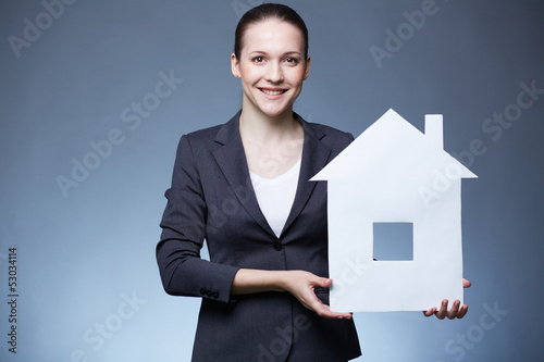 Photo: Woman with paper house Woman with paper house