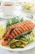 Salmon fried on a grill with zucchini.