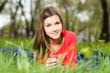 beautiful young girl laying in park