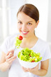Teenager girl eating salad