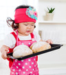 cute little asian holding tray of baked bread