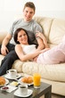 Photo: Lovely couple lying on couch in pajamas Lovely couple lying on couch in pajamas