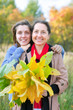 Photo: mature woman wirh adult daughter in autumn mature woman wirh adult daughter in autumn