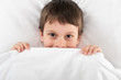 cheerful boy in bed