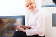 Female Senior at home in front of fireplace
