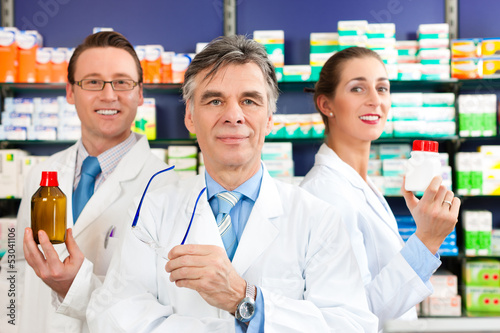 Photo: Team of pharmacists in pharmacy Team of pharmacists in pharmacy