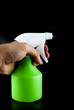 Green plastic sprayer isolated on black background