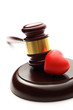 Judge's wooden gavel and red heart