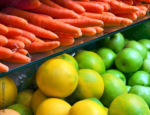 Photo: Vegetables and fruit on the counter in the store. Vegetables and fruit on the counter in the store.
