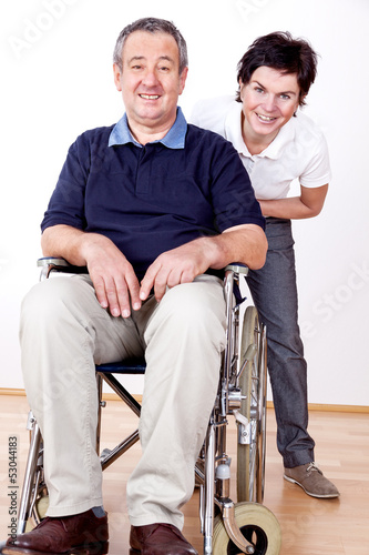 Photo: Woman pushing wheelchair Woman pushing wheelchair