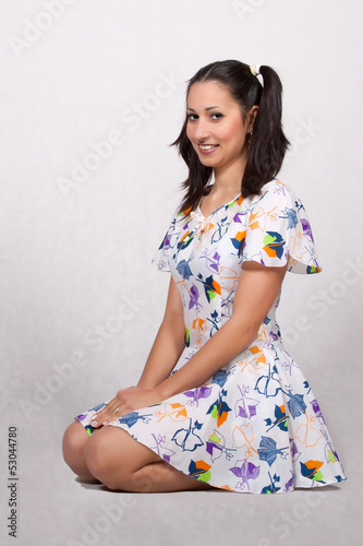 Photo: A girl with pigtails in colorful retro dress A girl with pigtails in colorful retro dress