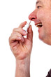 Man spraying nose drops
