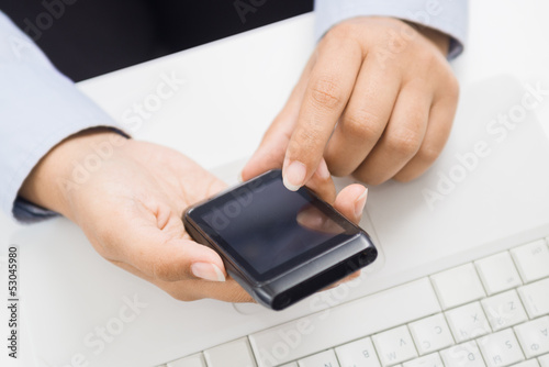 Photo: Business woman hands with smart phone at office Business woman hands with smart phone at office