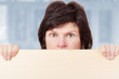 Foto: Woman stands behind the board Woman stands behind the board