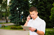 Businessman working on his tablet and talking on the phone