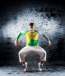 A young and sporty modern dancer on a grunge background