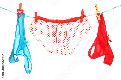 Photo: Women's panties hanging on rope isolated on white Women's panties hanging on rope isolated on white