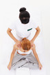 A young woman getting traditional thai stretching massage