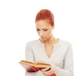 Foto: Young attractive woman with the book isolated on white Young attractive woman with the book isolated on white
