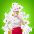 Asian female cook against milk splashes