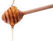 Foto: Honey dripping from a wooden honey dipper isolated on white back Honey dripping from a wooden honey dipper isolated on white back