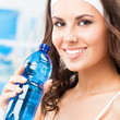 Woman drinking water, at fitness club
