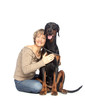 Young woman with black dobermann dog