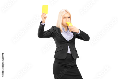 Photo: Angry businesswoman blowing a whistle and showing a yellow card Angry businesswoman blowing a whistle and showing a yellow card