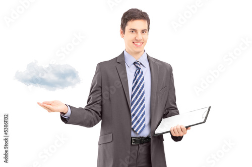 Photo: Man holding a clipboard and gesturing with hand, symbolizing clo Man holding a clipboard and gesturing with hand, symbolizing clo