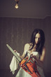 Photo: Woman cleaning her chainsaw Woman cleaning her chainsaw