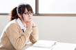 a young asian school girl studying