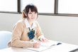 a young asian school girl studying