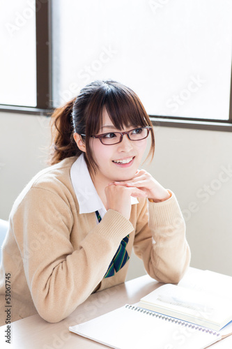 Photo: a young asian school girl studying a young asian school girl studying