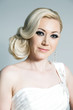 Studio portrait of beautiful blonde bride in white dress