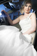 beautiful blonde bride in white dress in a car