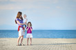 Mother and her kids by a sea