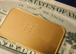 close-up of a 50g gold bar / ingot on a 20 Dollar note