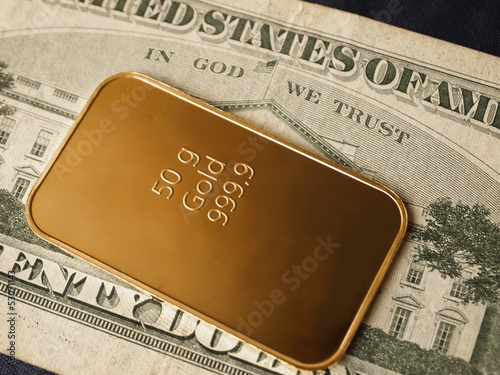 Photo: close-up of a 50g gold bar / ingot on a 20 Dollar note close-up of a 50g gold bar / ingot on a 20 Dollar note