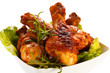 Foto: Grilled chicken legs and vegetables on white background Grilled chicken legs and vegetables on white background