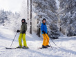 Teenage girl and boy skiing