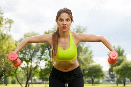 Photo: Young caucasian woman with dumbbells Young caucasian woman with dumbbells