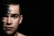 Handsome guy with artistic black shadow on his face