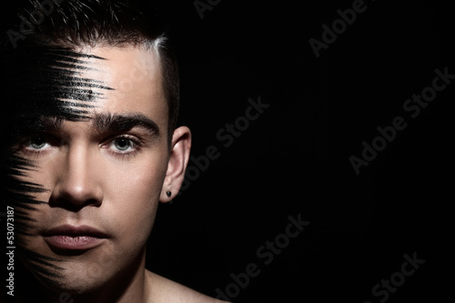 Photo: Handsome guy with artistic black shadow on his face Handsome guy with artistic black shadow on his face