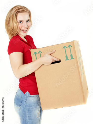 Photo: Pretty young woman carrying a moving box Pretty young woman carrying a moving box