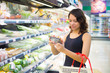 woman buys in the supermarket tomato