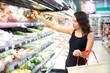 woman buys in the supermarket tomato