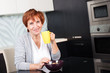 Happy adult woman on kitchen