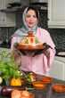Photo: Immigrant lady with traditional dish Immigrant lady with traditional dish
