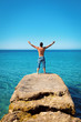 Man with Arms Wide Open on Blue Tropical Sea