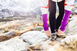Runner tying sport shoe in mountains on trail
